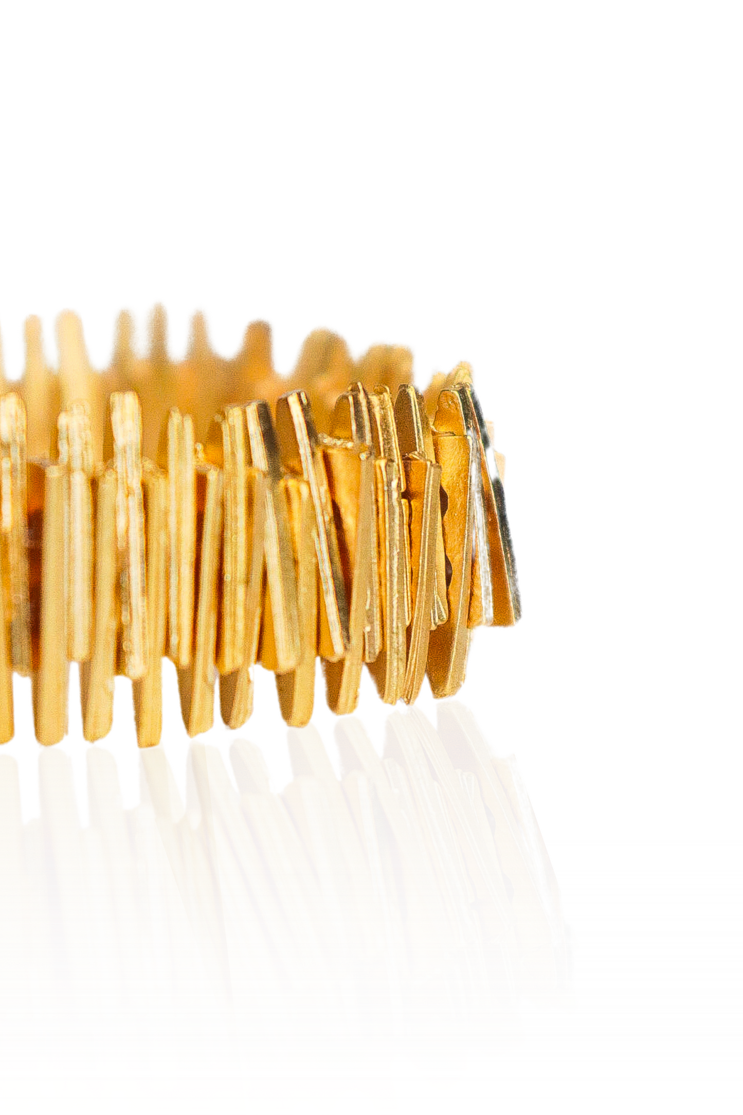 Close-up of gold abstract bar bracelet on elastic band