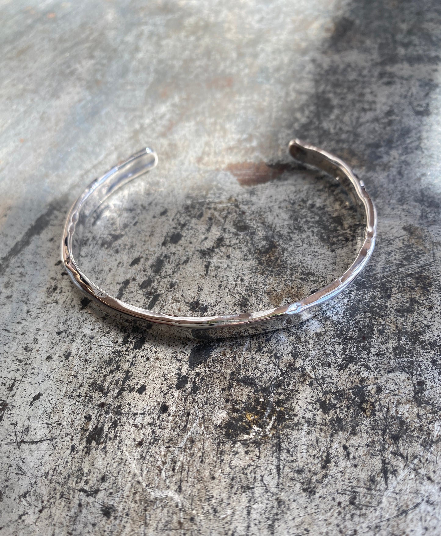 Open-back silver cuff bracelet with textured finish