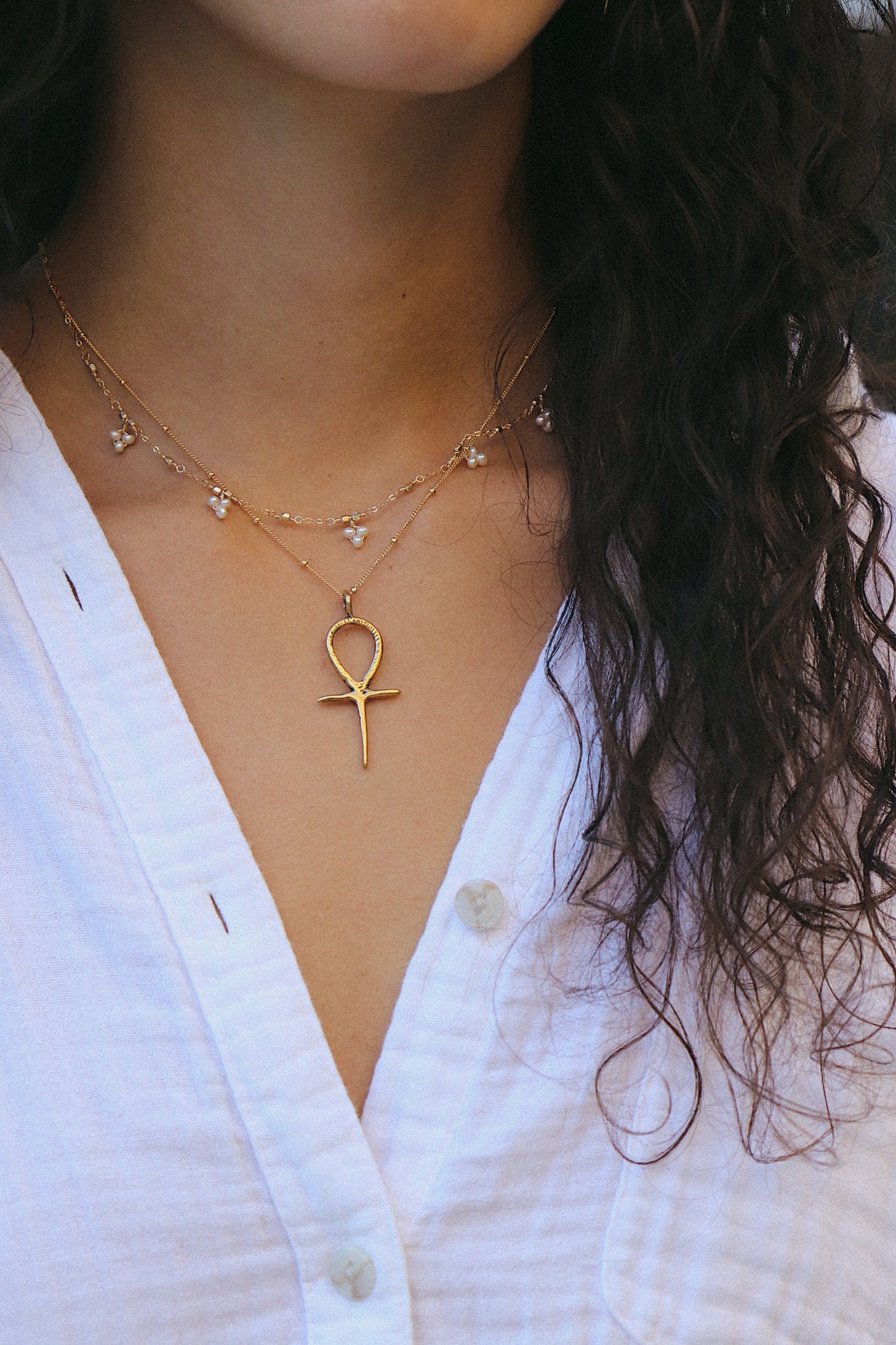 Bronze Ankh Necklace styled with other boho necklace on model