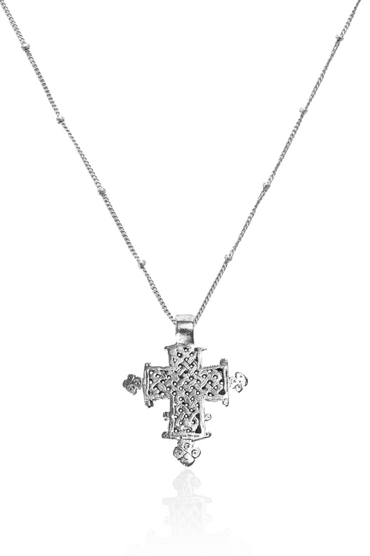 Close-up of silver lattice Ethiopian cross on chain