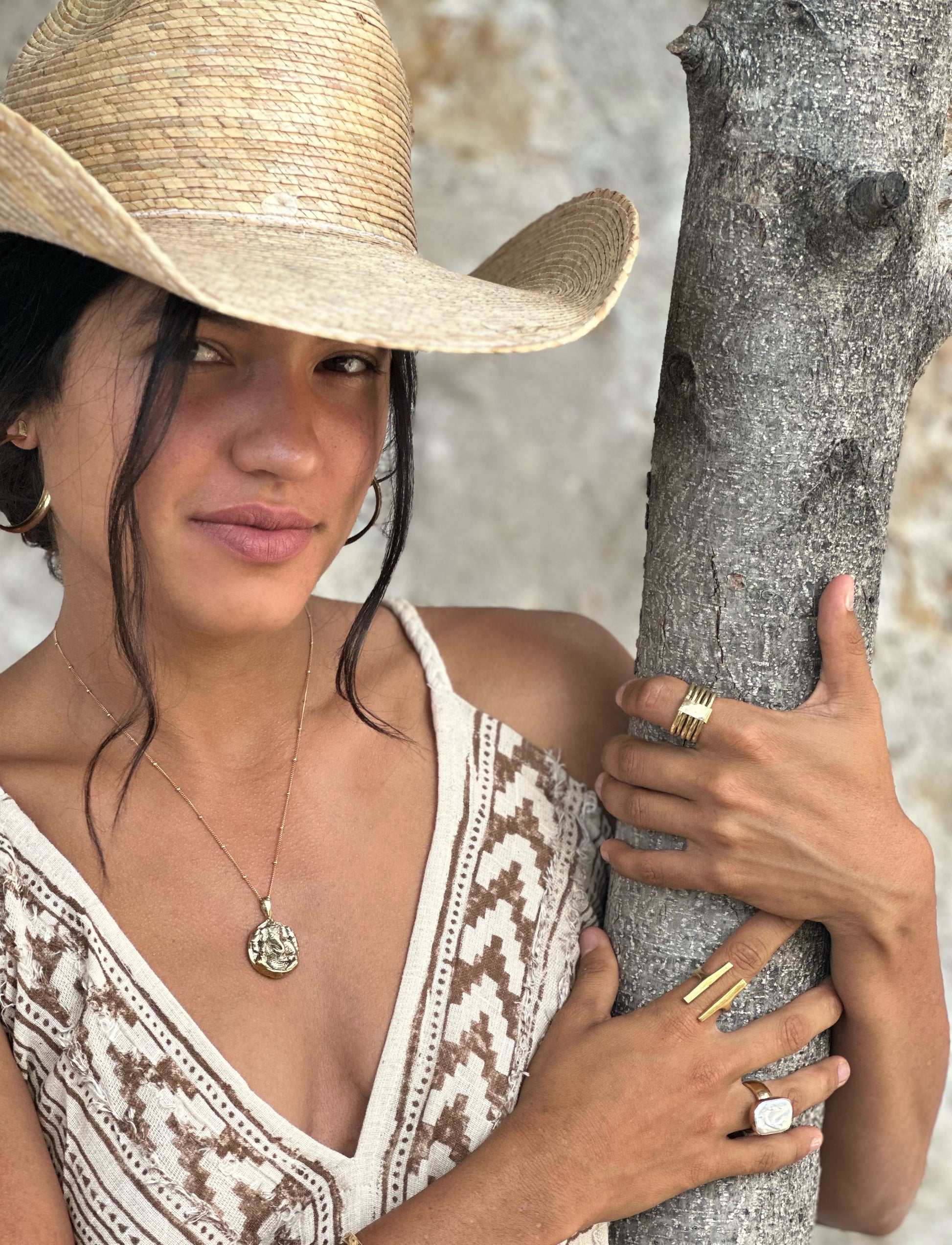 Gold Ganesha pendant with satellite chain and textured finish on model