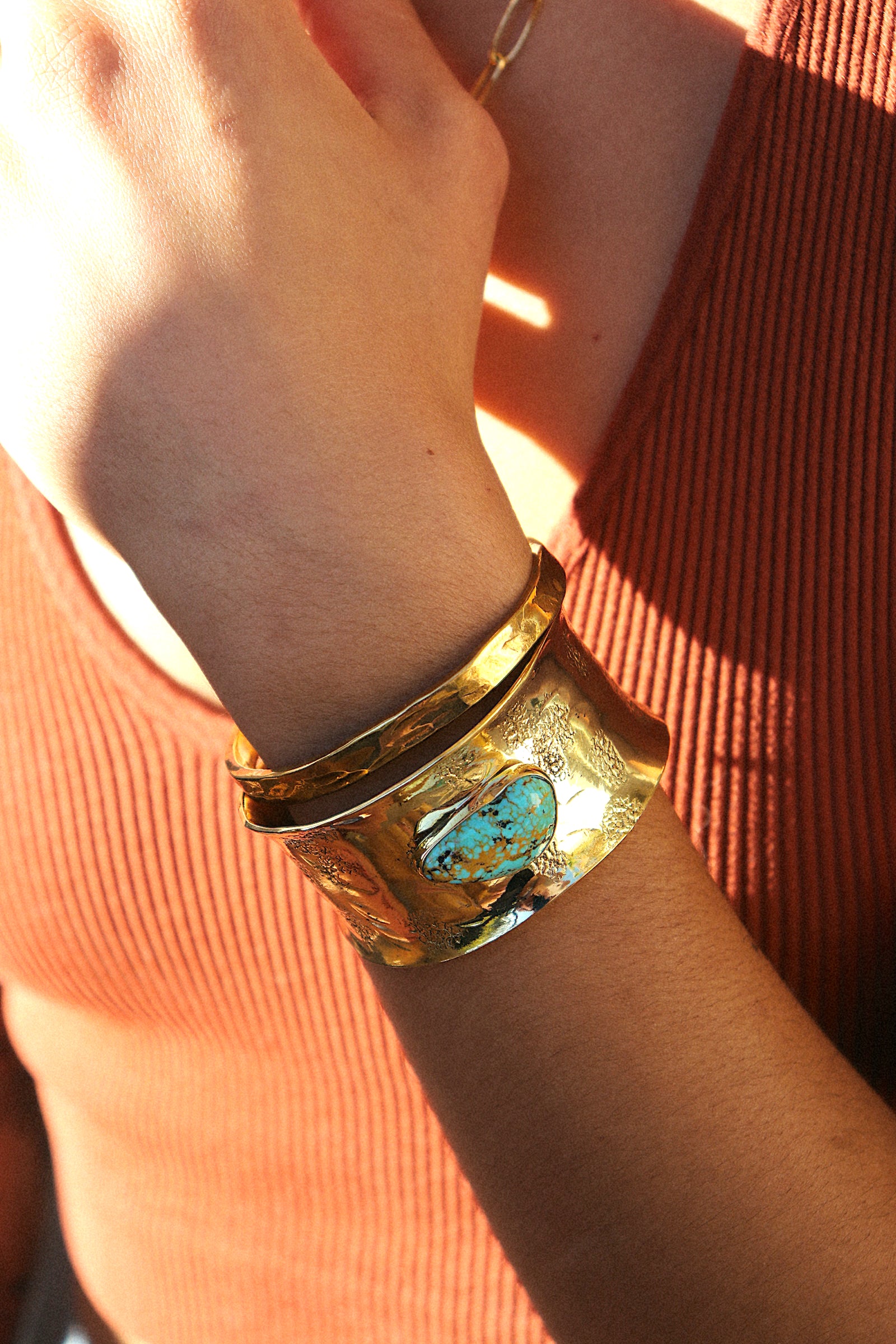 Adjustable gold cuff bracelet styled on wrist