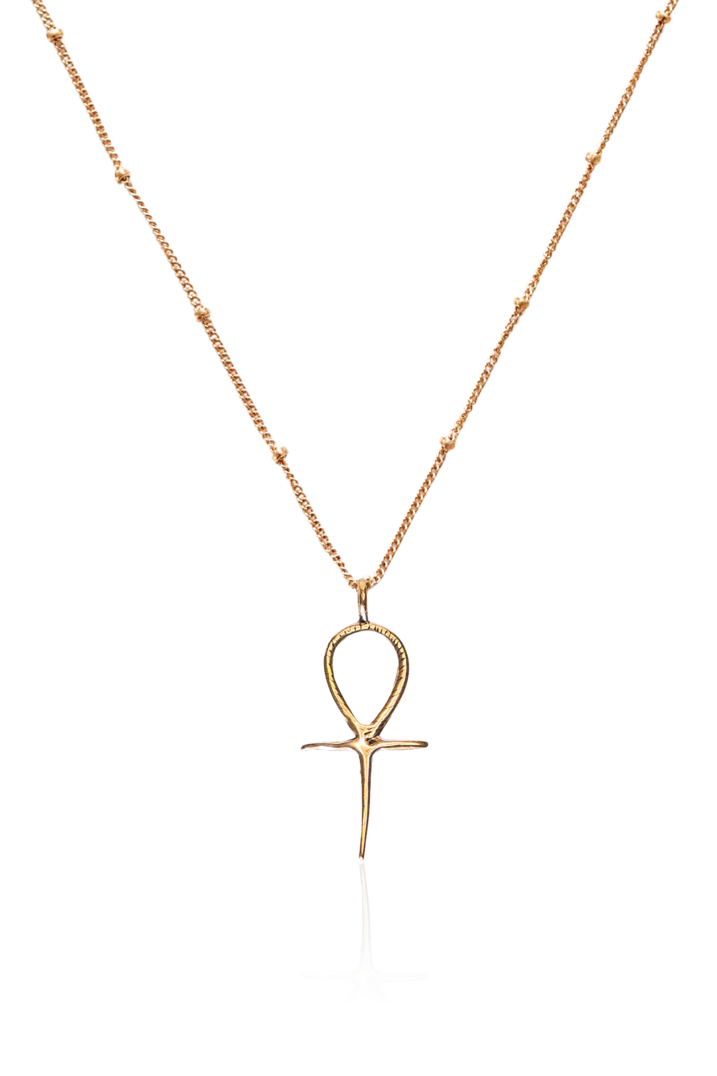 Close-up of detailed bronze Ankh pendant on gold chain