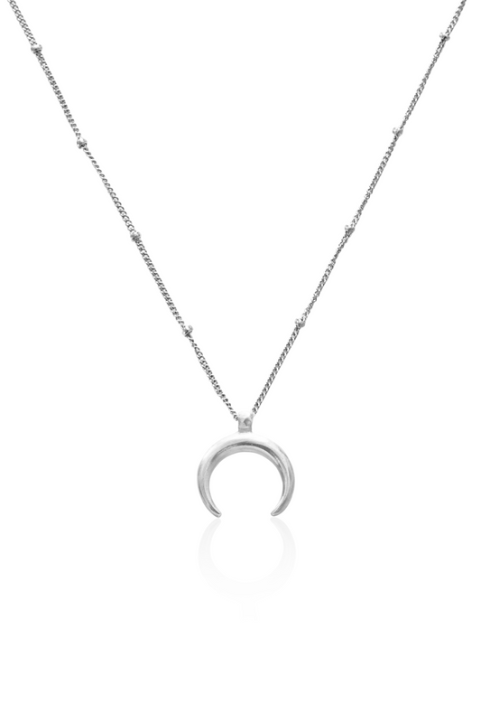 Close-up of silver crescent moon hanging downward