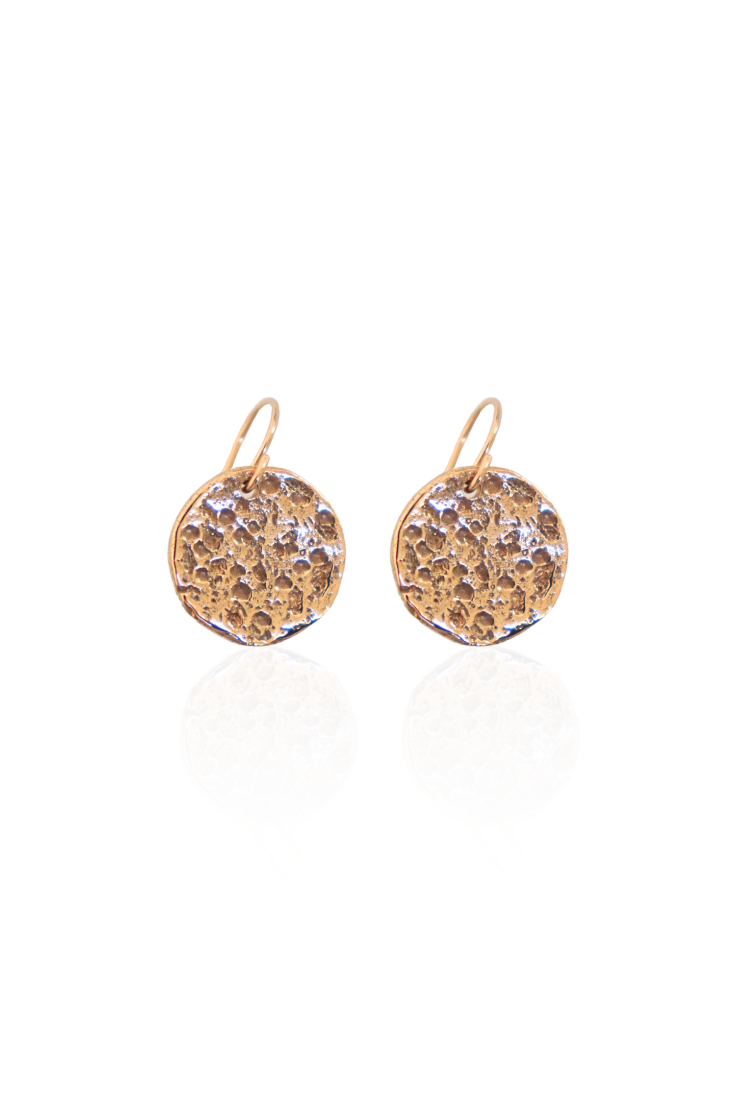 Close-up of bronze medallion earrings on French hooks