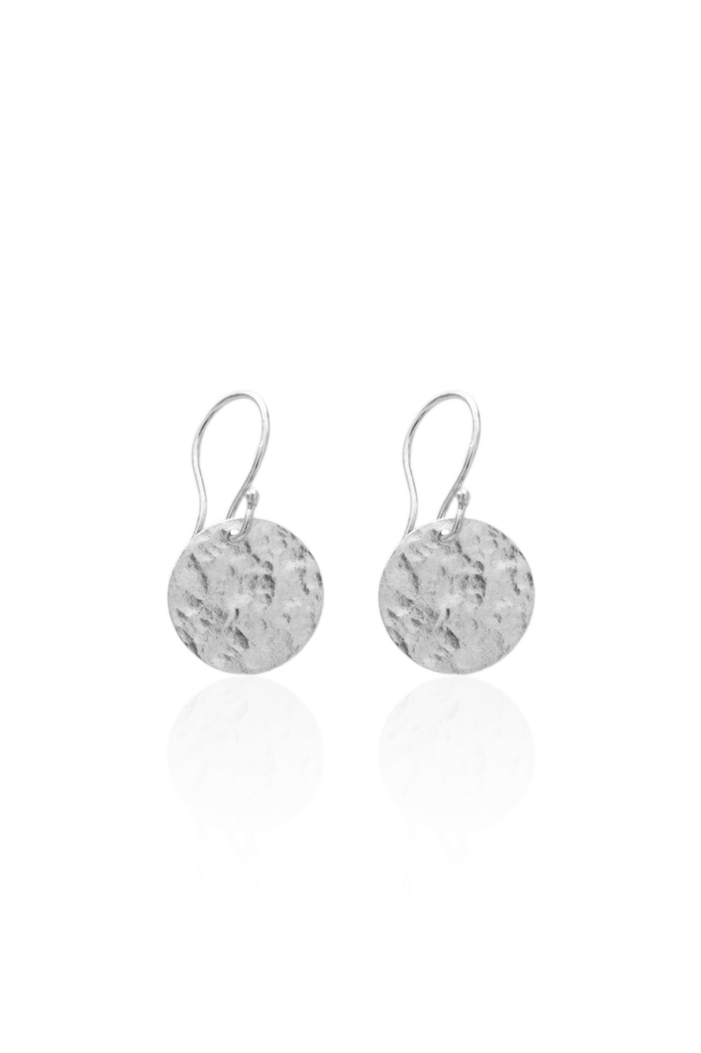 Close-up of silver medallion earrings on French hooks