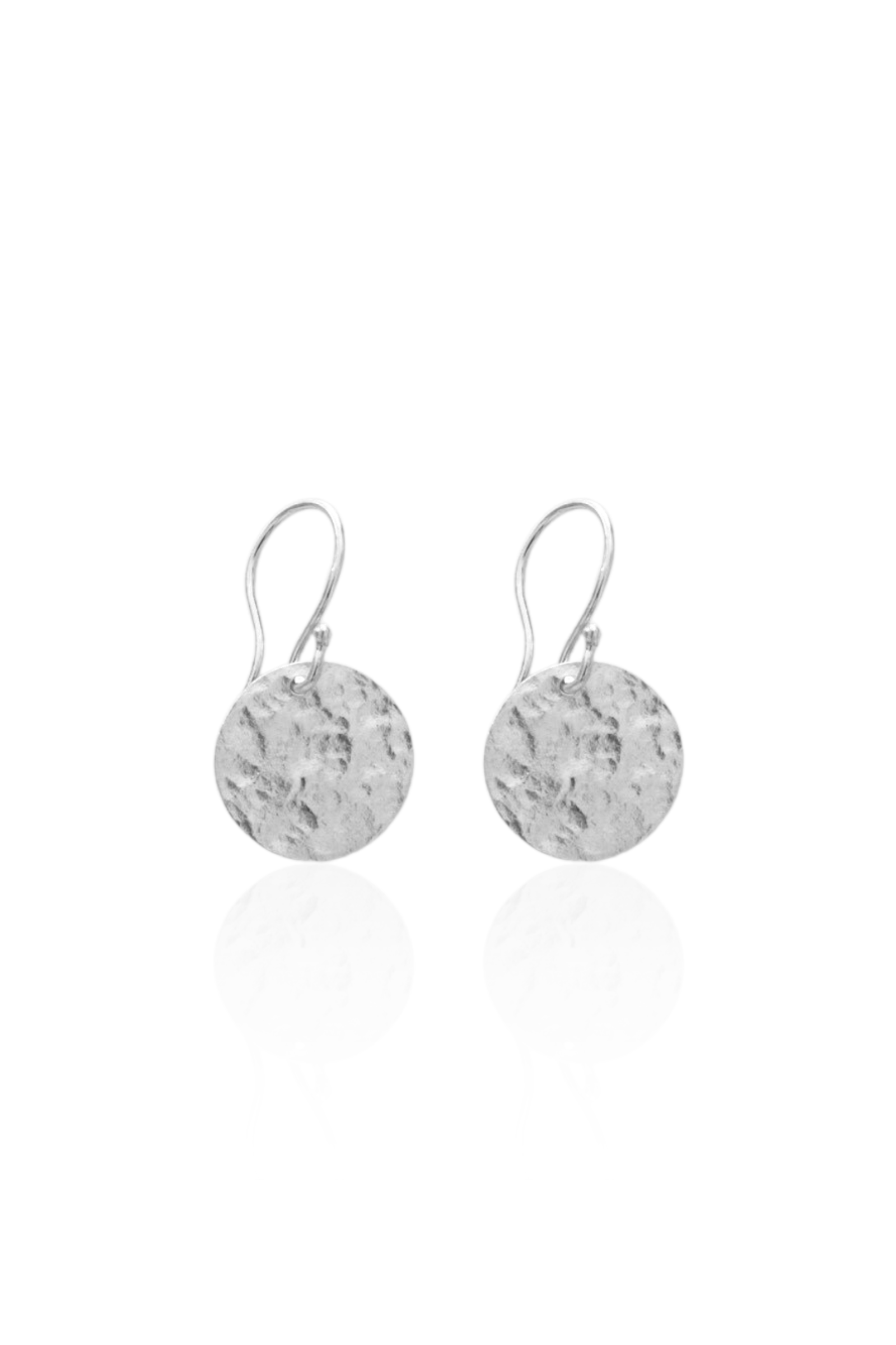 Close-up of silver medallion earrings on French hooks