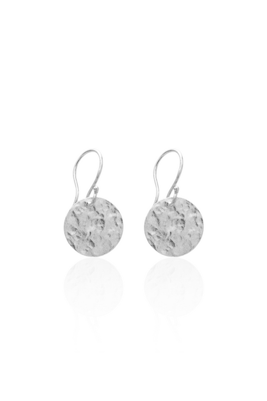 Close-up of silver medallion earrings on French hooks
