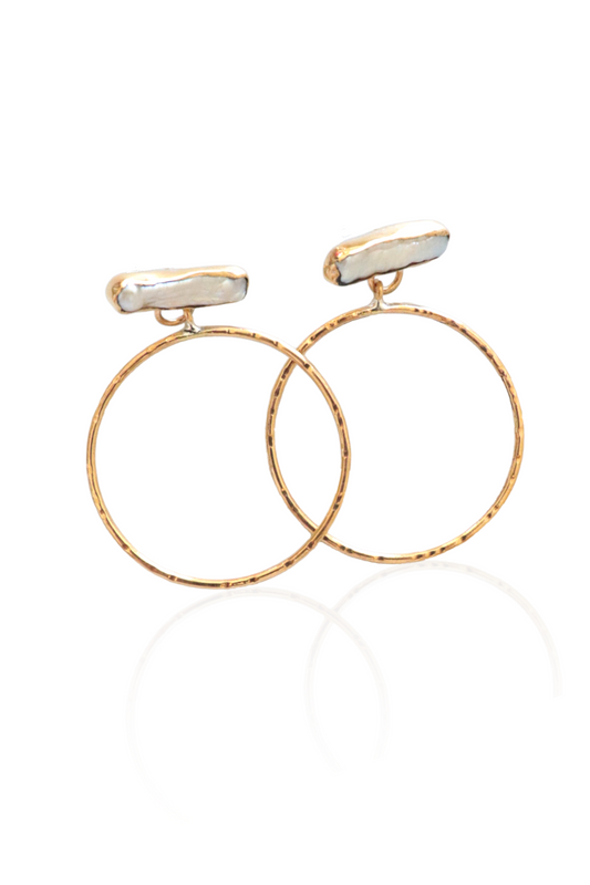 Close-up of gold hammered hoops with pearls