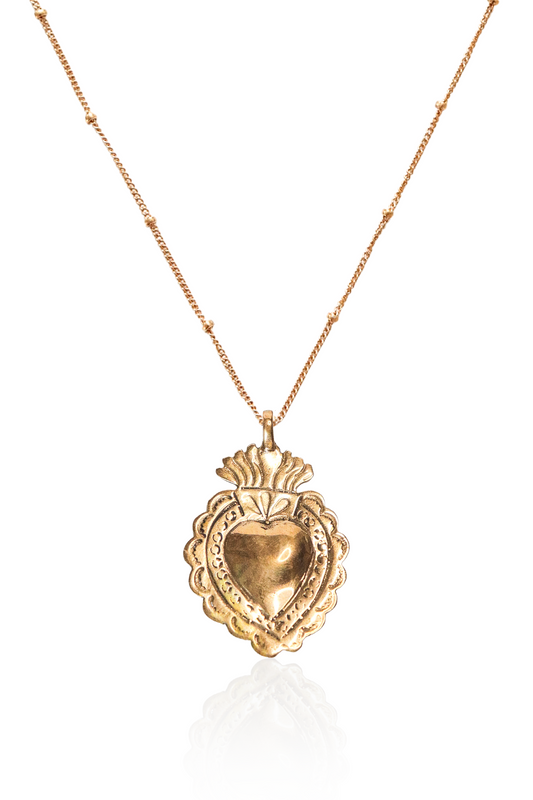 Close-up of gold sacred heart pendant necklace