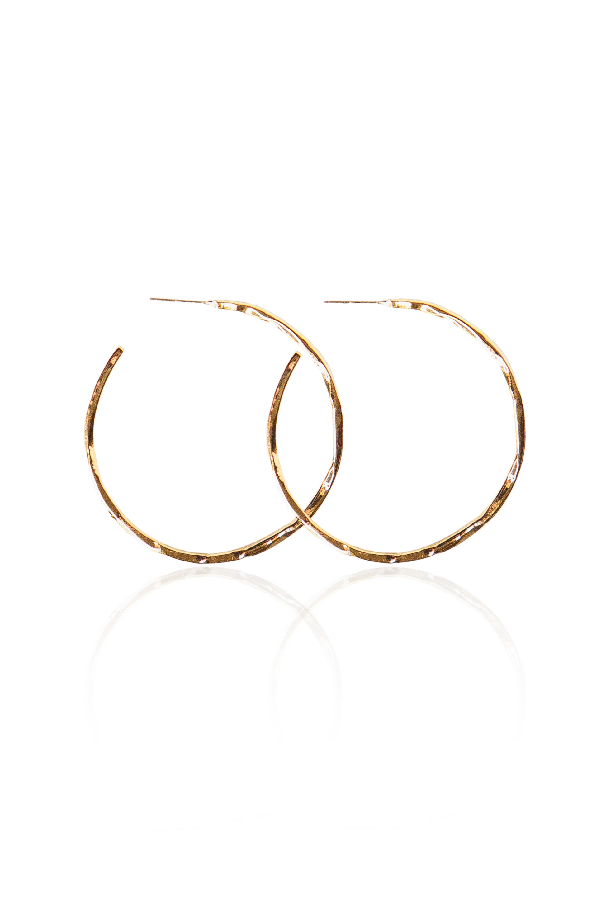 lose-up of hand-hammered gold semi-hoop earrings