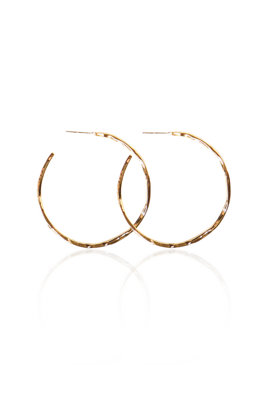 lose-up of hand-hammered gold semi-hoop earrings