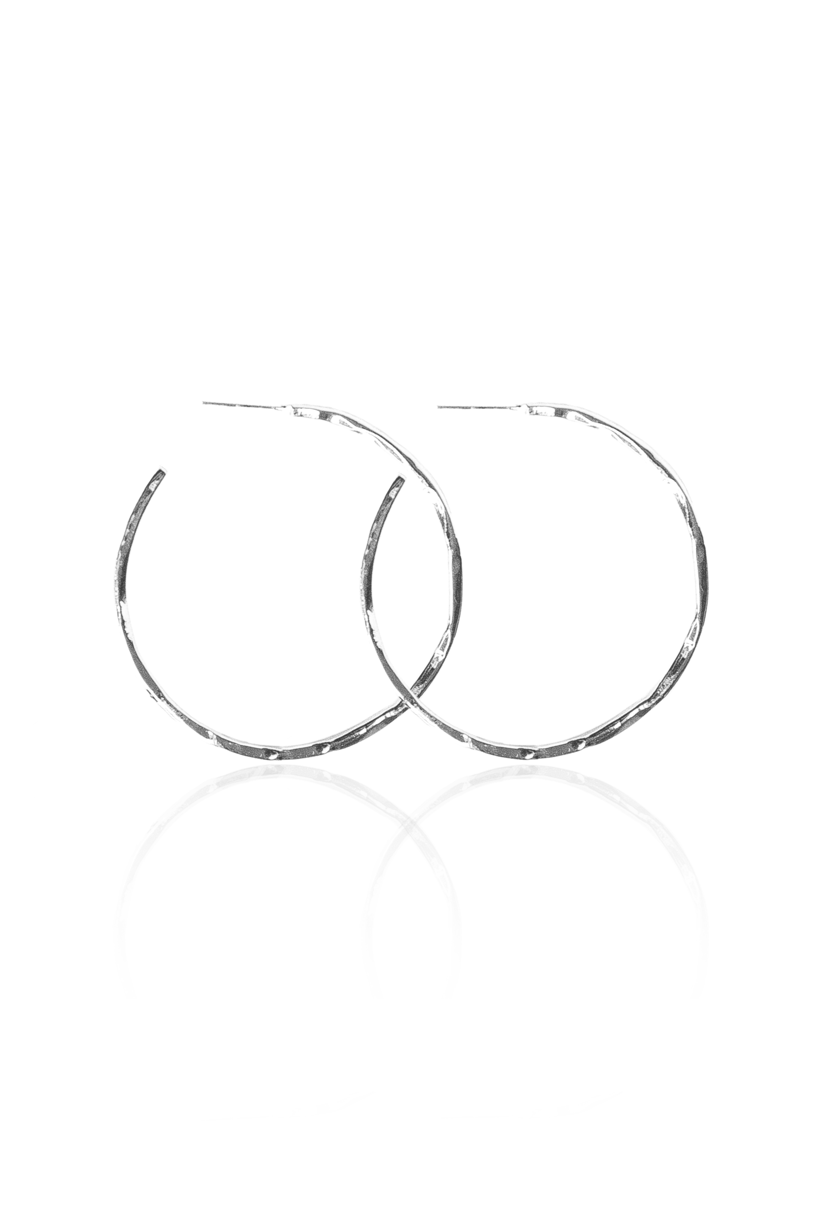 Close-up of hand-hammered silver semi-hoop earrings