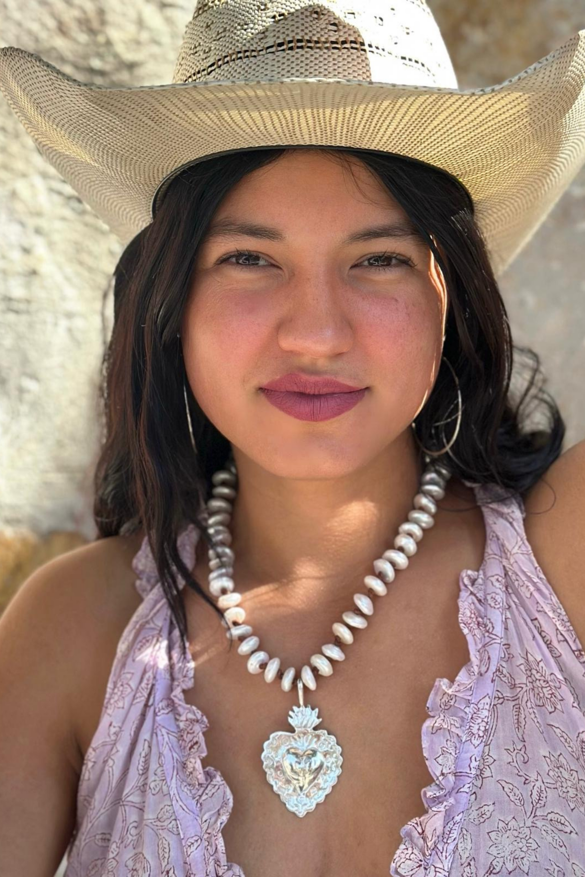 Boho pearl necklace with silver Sacred Heart pendant on model