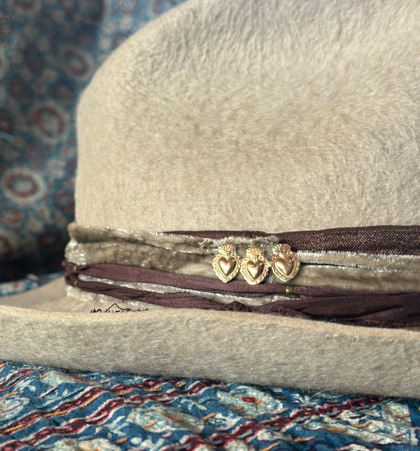 Decorative bronze heart brooch on a hat