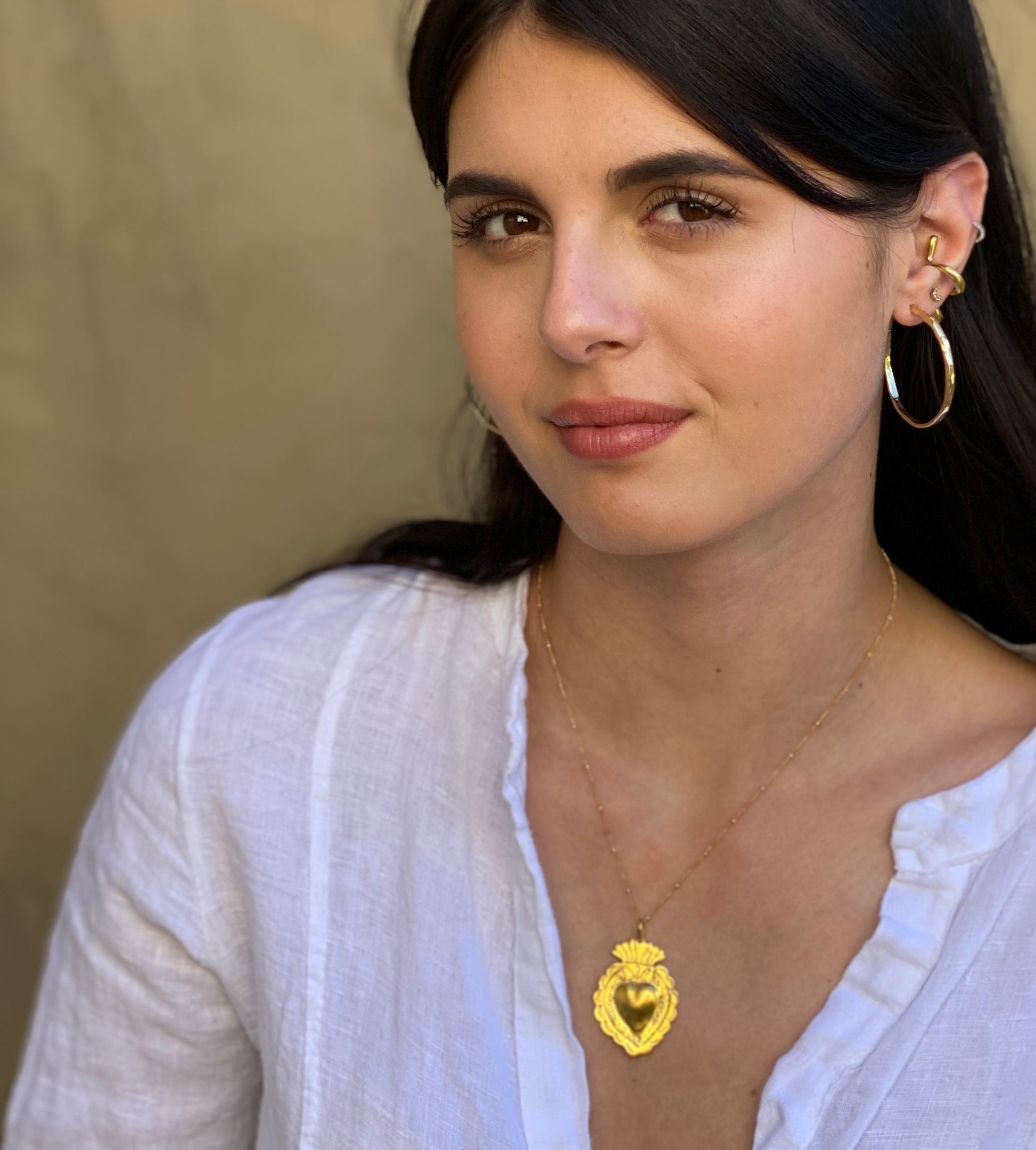 Thin gold bohemian hoops styled on model