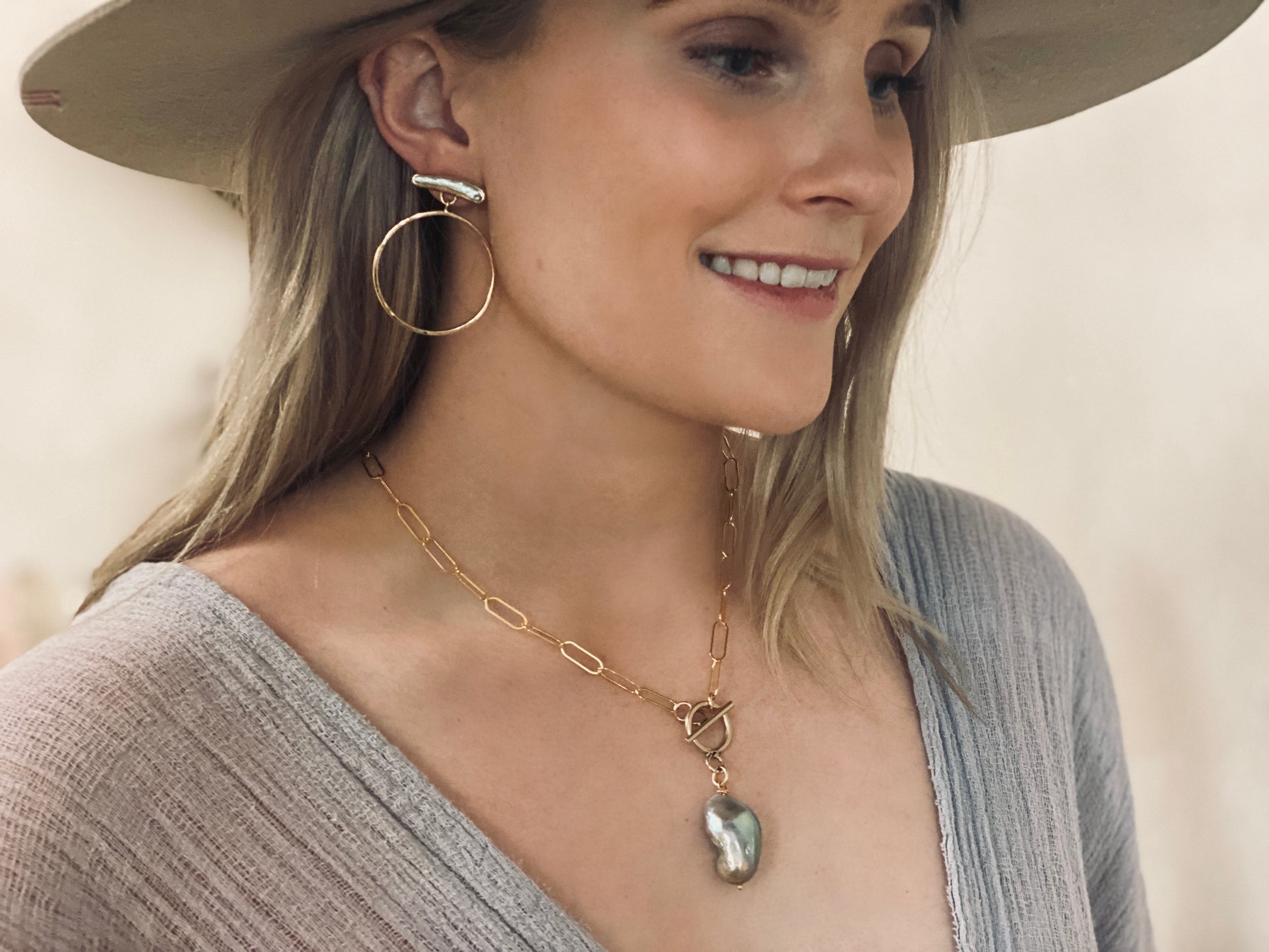 Pearl and gold hoop earrings styled on model